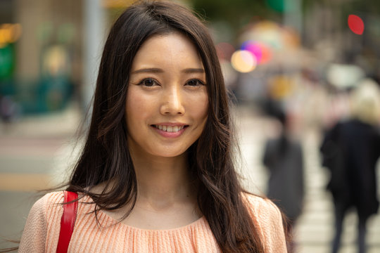 Asian woman in city smile happy face portrait