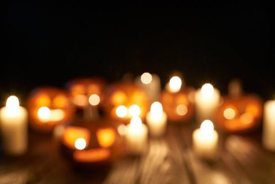 Defocused Jack-o-latern Halloween pumpkins with candles