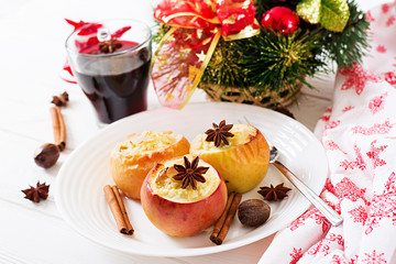 Stuffed baked apples with cottage cheese, raisins and almonds for Christmas on a white background. Xmas food dessert.