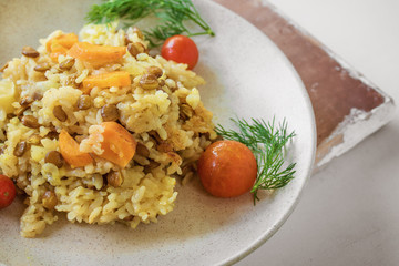 Rice with red lentils, vegetables and herbs, macro, vegan