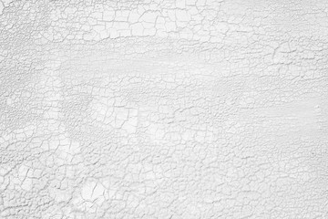 Old weathered woden plate with white cracked enamel.