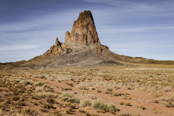 Fototapeta premium Desert floor and rock peak in Monument Valley
