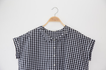 Small scott colour blouse is clothes hanger on white background.