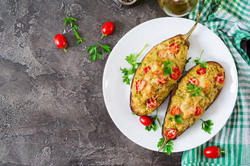 Minced meat chicken and vegetables stuffed eggplants on a grey background. Dinner food. Top view. Flat lay