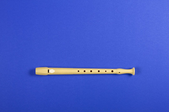 Musical Instrument Flute On Blue Color Background.