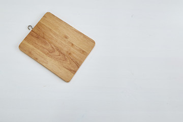 Wooden cutting board on white table