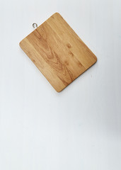 Wooden cutting board on white table