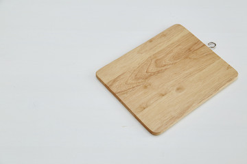 Wooden cutting board on white table