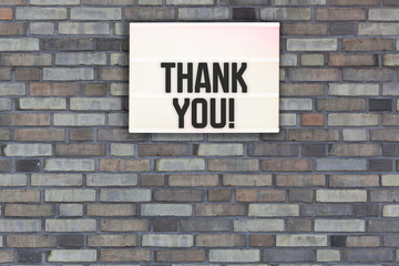 Fototapeta na wymiar Thank You message on Brick wall with light box