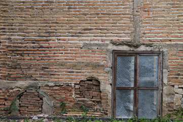 Closeup of vintage brick wall and the door of old tobacco plant.