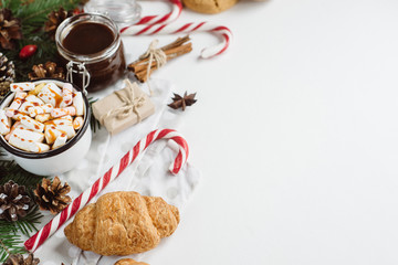 Winter hot drink. Christmas hot chocolate or cocoa with marshmallow, cookies   on white background with christmas decorations. Flat Lay.