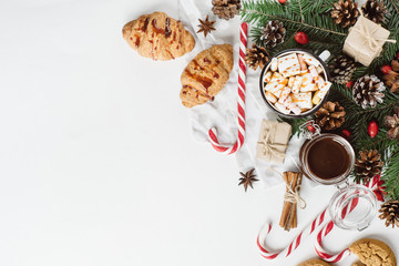 Winter hot drink. Christmas hot chocolate or cocoa with marshmallow, cookies   on white background with christmas decorations. Flat Lay.