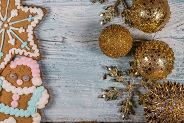 Two Gingerbread Cookies and Christmas Decorations On Wooden Background