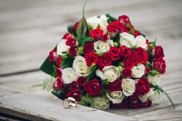 Bridal bouquet with two rings at the foreground.