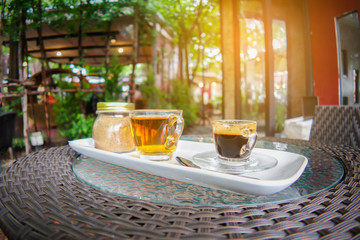 Coffee and tea cup with brown sugar jar on table 