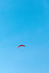 flying paraglider in the blue sky