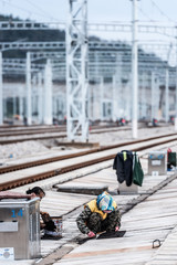 Fototapeta premium Railway workers maintain high-speed railway tracks at a high-speed railway station in kunming, southwest China's yunnan province, sept 28, 2018