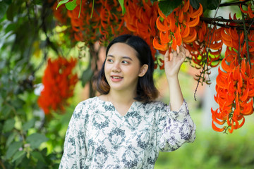 Pretty asian girl enjoy with flowers
