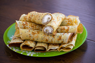 Pancakes rolls with cottage cheese. Pancakes with cheese. Shrovetide.