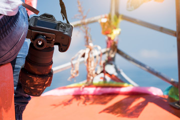 Nature Photography sitting and holding camera and len during taking wildlife animal