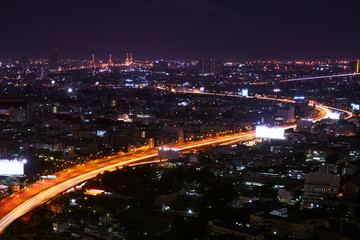 Fototapeta na wymiar scenic of night cityscape with spped light tail on expressway