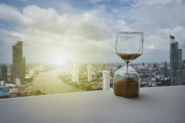 hourglass on balcony and cityscape view background