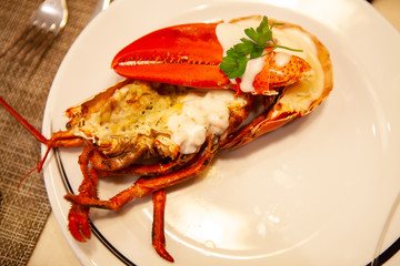 Simple yet delicious. Hot and freshly baked halved Lobster with butter. Fresh, juicy and tasty bright red Maine Lobster or American lobster. Sweet and flavorful lobster. Rich in omega-3 fatty acid