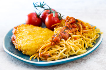 Escalope of spaghetti with tomatoes sauce and basil