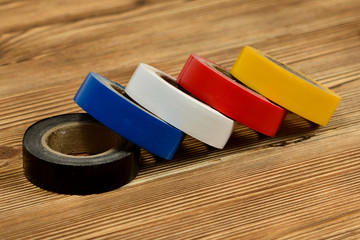 Rolls of colored duct tape on wooden table