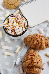 Winter Flat Lay . Hot chocolate or cocoa with marshmallow , cookies, notebook with  on white background.