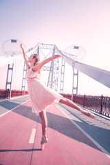 Creative outlet. Delighted positive woman smiling while expressing herself in dance © Viacheslav Yakobchuk