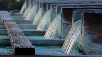 Natural hot spring onsen river flowing along wood tube row at kusatsu gunma Japan