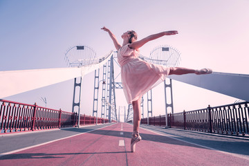 Solo dancer. Positive attractive woman jumping up while dancing alone on the bridge © Viacheslav Yakobchuk