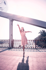 At sunset. Beautiful skilled ballerina standing against the sun while dancing © Viacheslav Yakobchuk