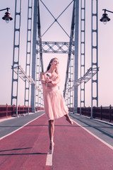 For you. Nice tender woman giving you a flower while dancing on the bridge © Viacheslav Yakobchuk