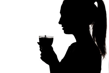 silhouette of girl drinking tea, femali holding ih hands cup with hot beverage, woman face profile on a white background