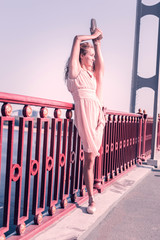 Excellent flexibility. Delighted skilled woman holding her leg up while showing her flexibility © Viacheslav Yakobchuk