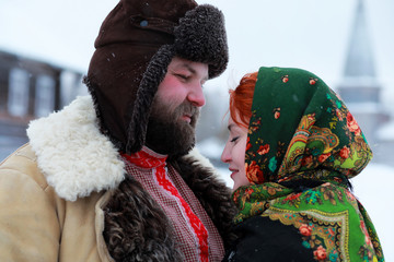 Couple in traditional winter costume of peasant in russia