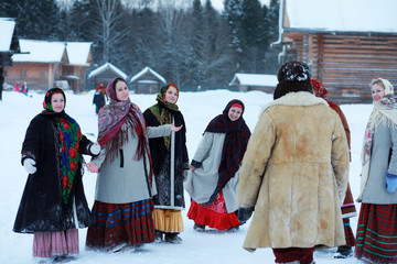 young girls in traditional costumes of the Russian north in wint