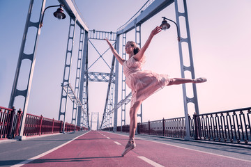 Like a feather. Beautiful graceful ballerina jumping in the air while feeling very light © Viacheslav Yakobchuk