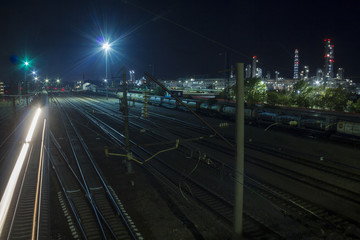 Fototapeta na wymiar Railway tracks on the territory of a huge chemical plant