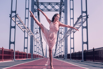 Professional dancer. Attractive pleasant woman standing barefooted on the bridge while dancing © Viacheslav Yakobchuk