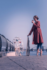 Tasty drink. Joyful young dancer drinking her coffee while standing on the pointe shoes © Viacheslav Yakobchuk