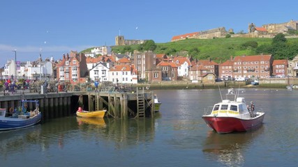 Whitby fishing trips boat in the harbour on a sunny afternoon.