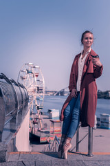 Delicious cappuccino. Positive nice woman standing with a cup of coffee while looking around © Viacheslav Yakobchuk