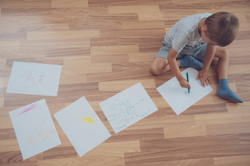 child does his homework, writes and draws