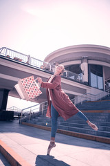 Being a shopaholic. Joyful nice woman feeling very happy while holding her shopping bags © Viacheslav Yakobchuk