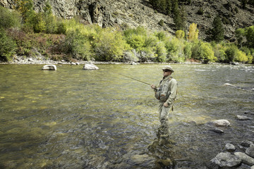 Fly Fisher man in the Rockies