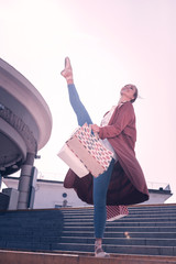 Shopping time. Joyful happy ballerina going down the stairs while holding shopping bags © Viacheslav Yakobchuk