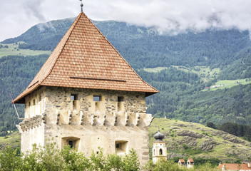 Fototapeta na wymiar Glorenza (Glums) in South Tyrol/Trentino Alto Adige, Italy. Church tower with the city walls
